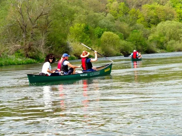 kanuverleih-kanutouren-kanuvermietung-kanuta-47 Eine Gruppe von Menschen paddelt in einem Kanu auf einem Fluss.